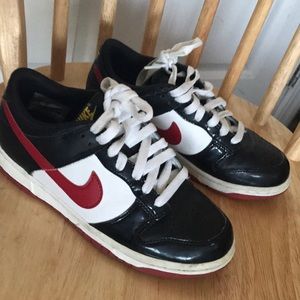 Vintage 2003 red and black Nikes dunks on white